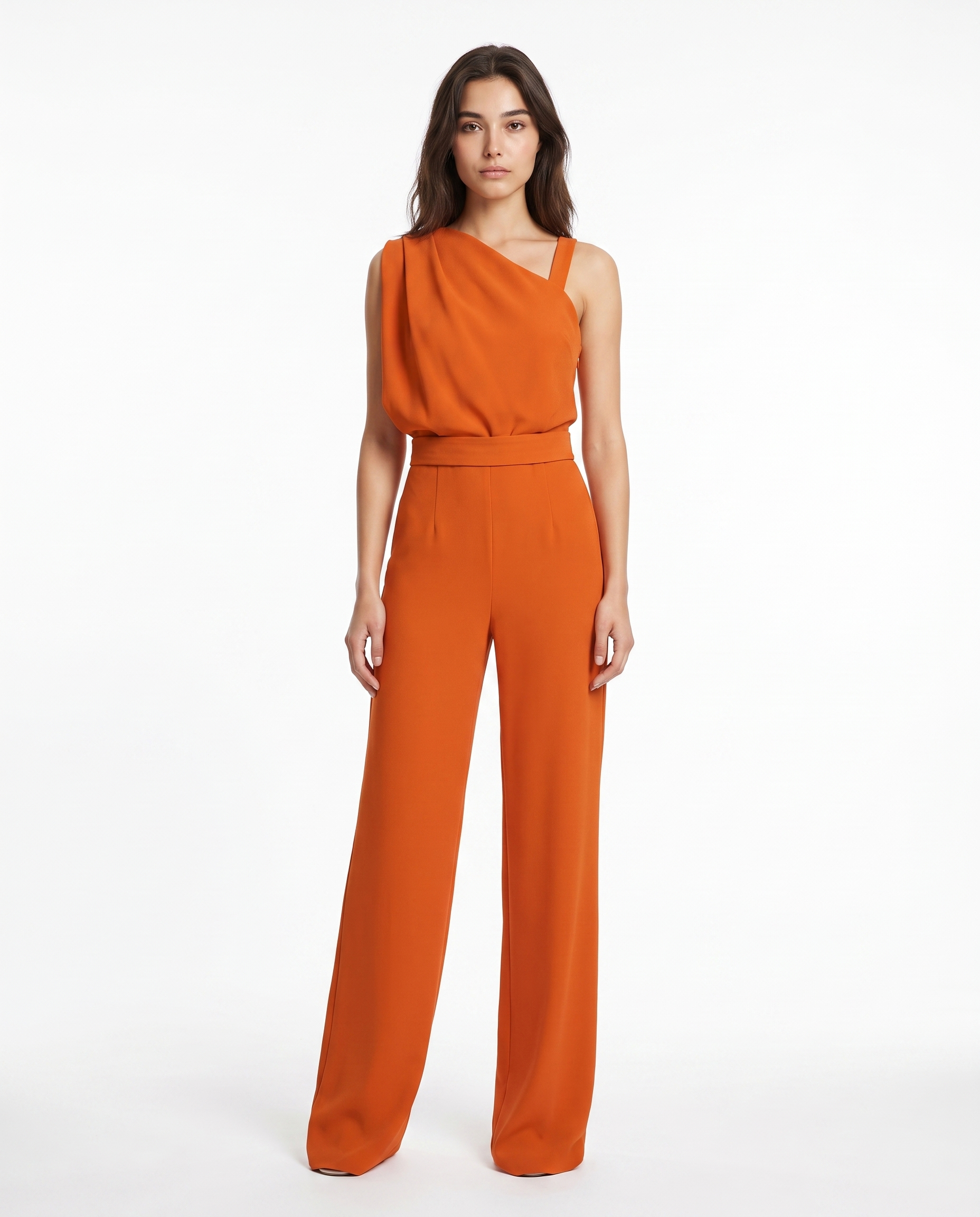 Orange sleeveless belted jumpsuit with asymmetrical neckline and wide-leg pants.