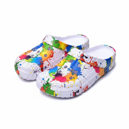 Ivory air-cushion clogs pair with multicolor paint-splatter print and thick molded sole