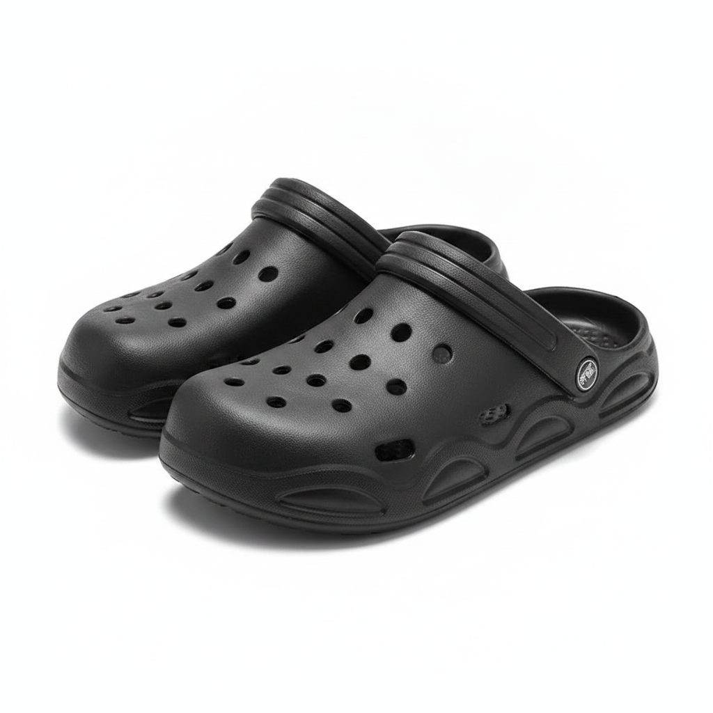Black unisex clogs with adjustable strap detail, slip-on with perforated upper