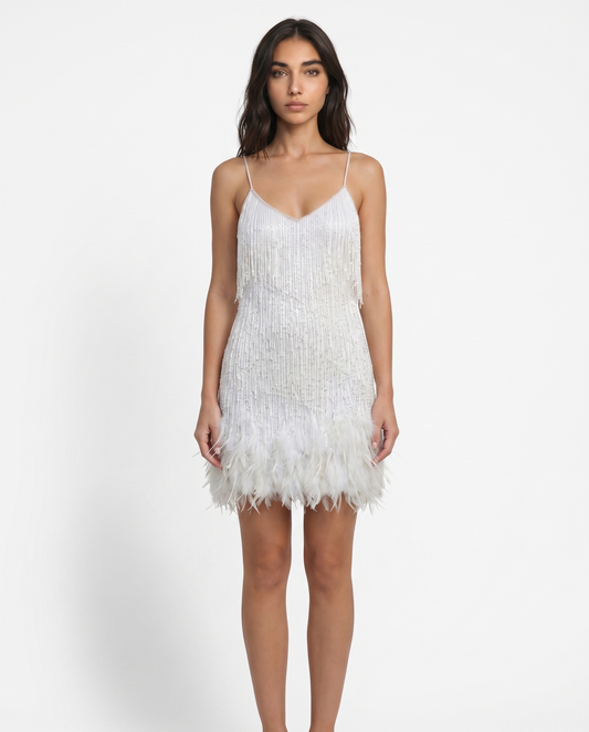 White sequin mini dress with spaghetti straps and feather fringe hem