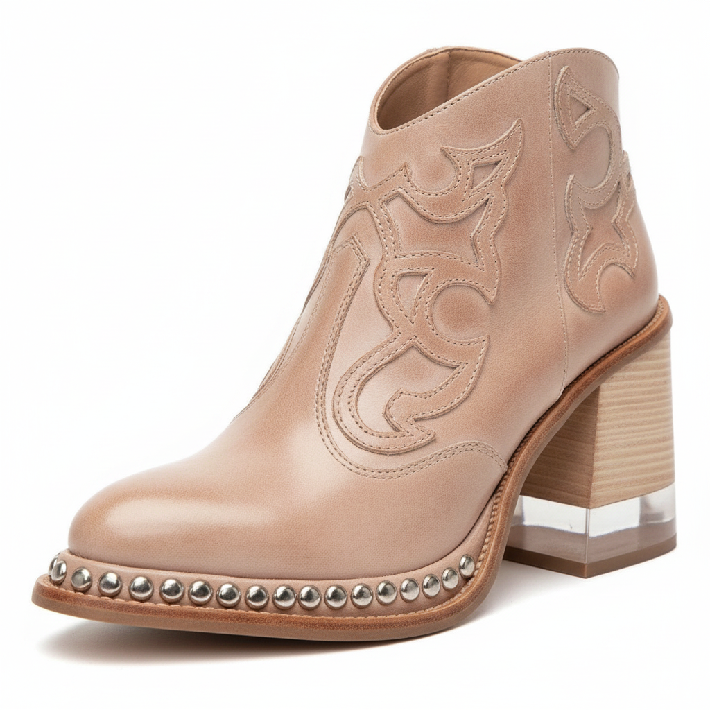 Women's western ankle boots in blush beige with ornate stitching and silver-stud trim at sole