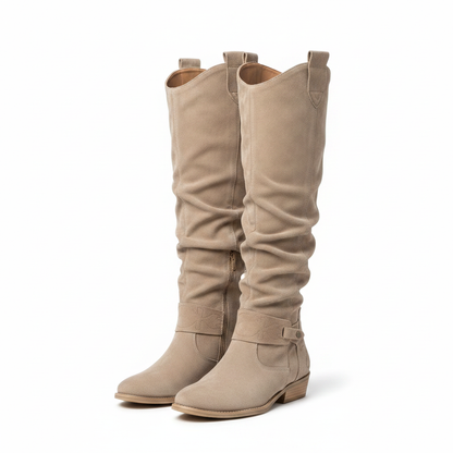 Beige knee-high flat boots with buckle strap detail and low sole