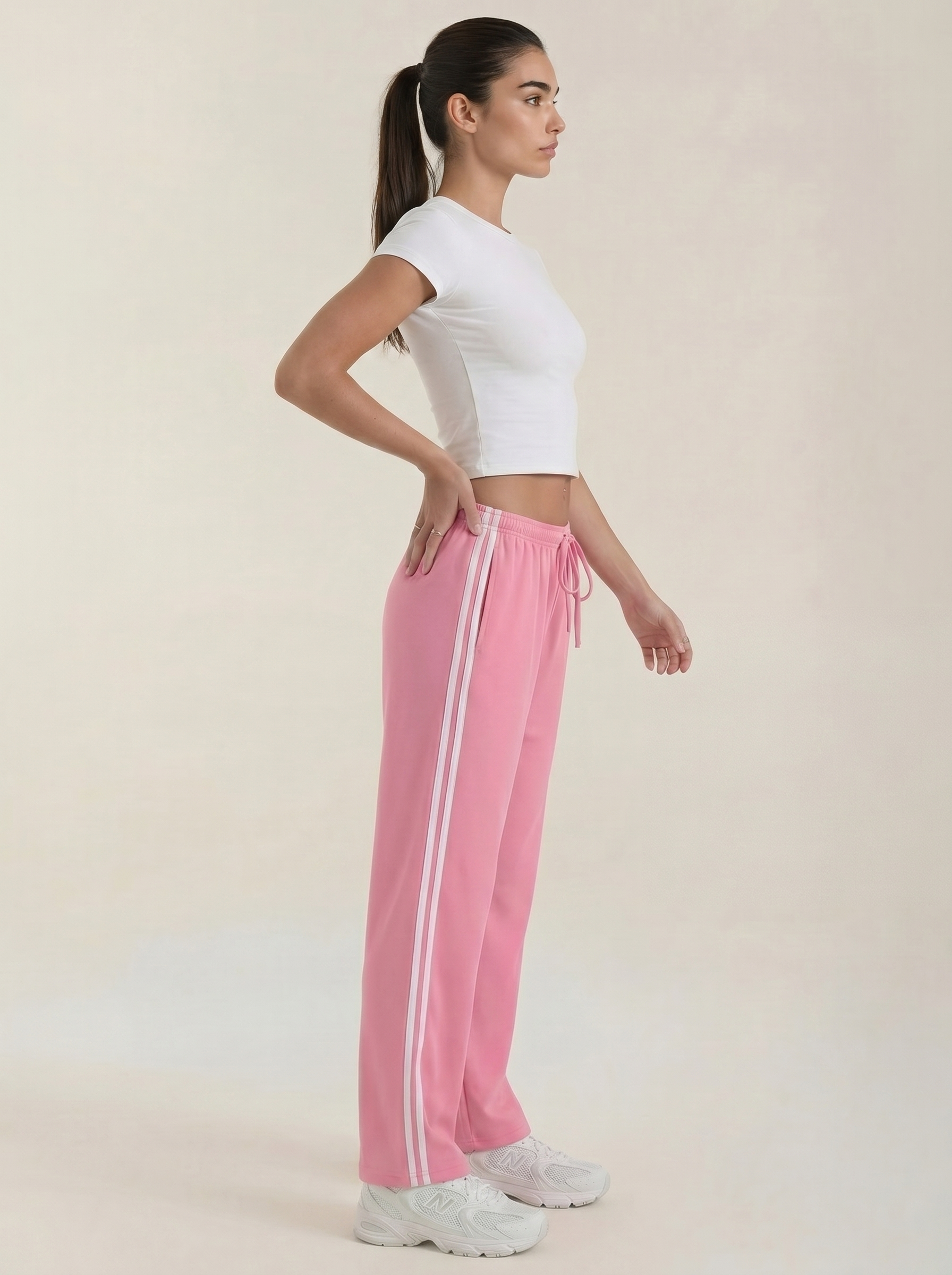 Pink wide-leg track pants with elastic drawstring waist and two white side stripes