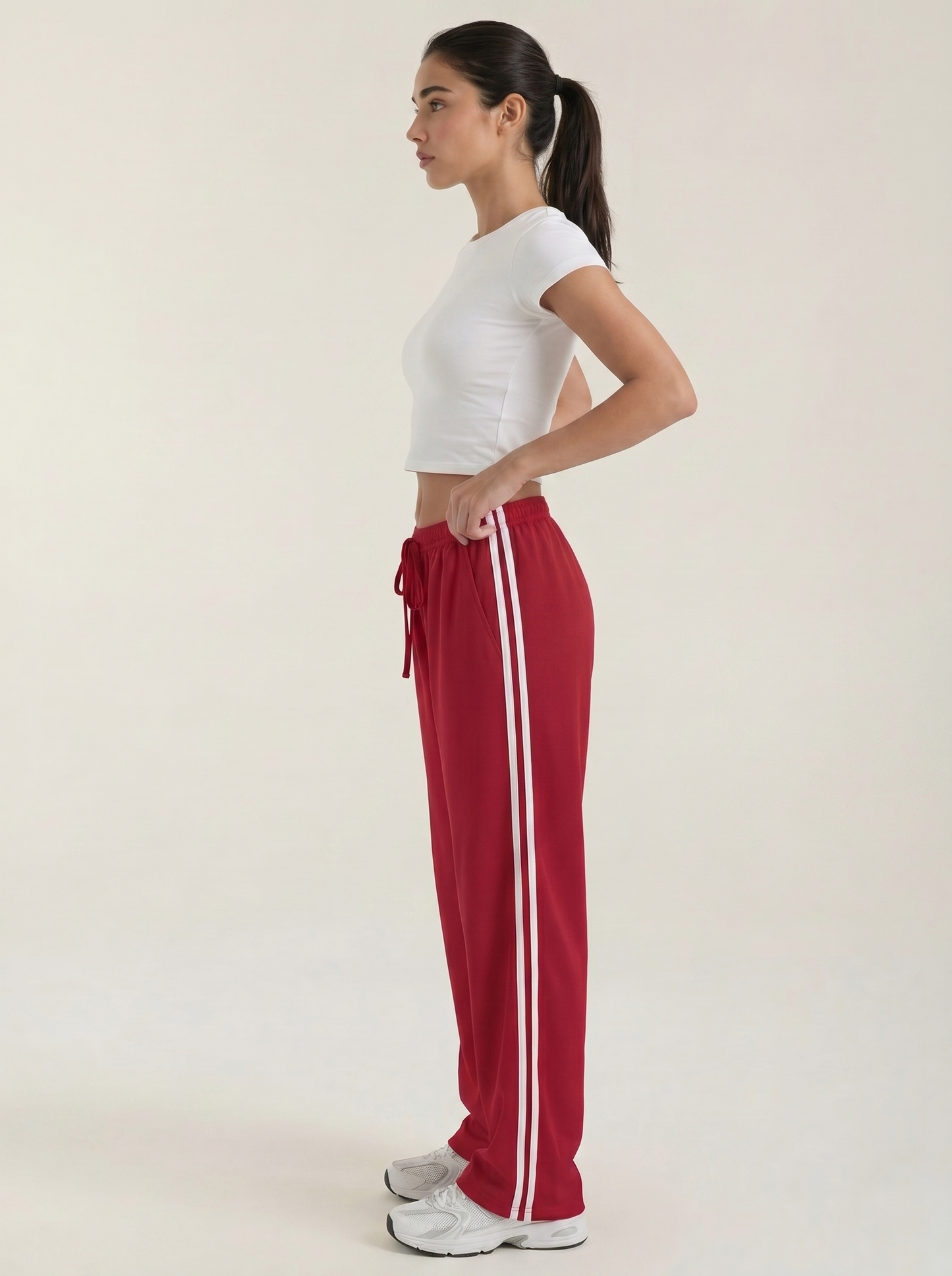 Red wide-leg track pants with drawstring elastic waist and long white side stripe detail