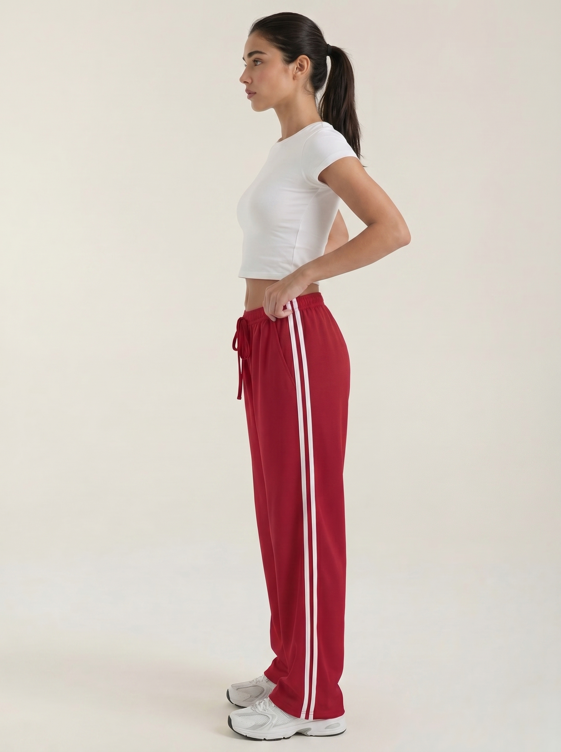 Red wide-leg track pants with drawstring elastic waist and long white side stripe detail