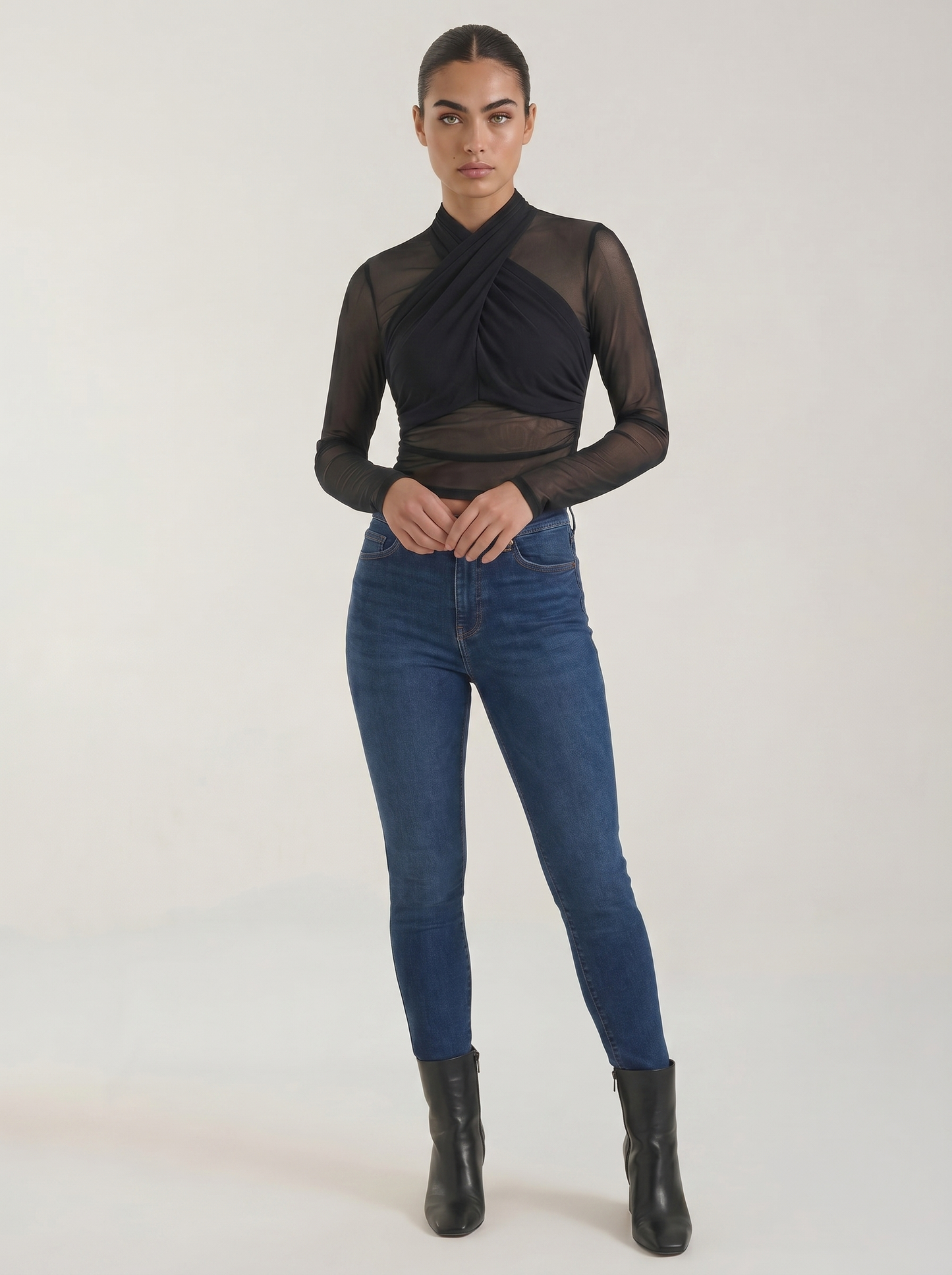Black sheer wrap mesh top with long sleeves and crossed surplice neckline